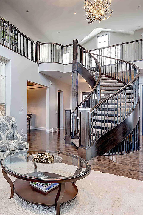 Luxury Home Curved Stairs | Diminishing Spindles